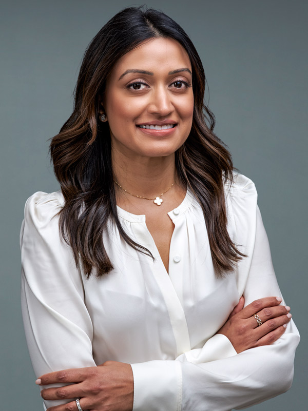 a woman with long brown hair wearing a white blouse