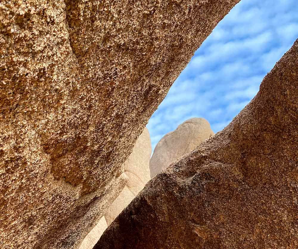 a rock formations with blue sky and clouds