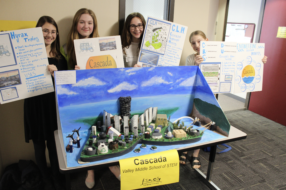 a group of girls holding up posters