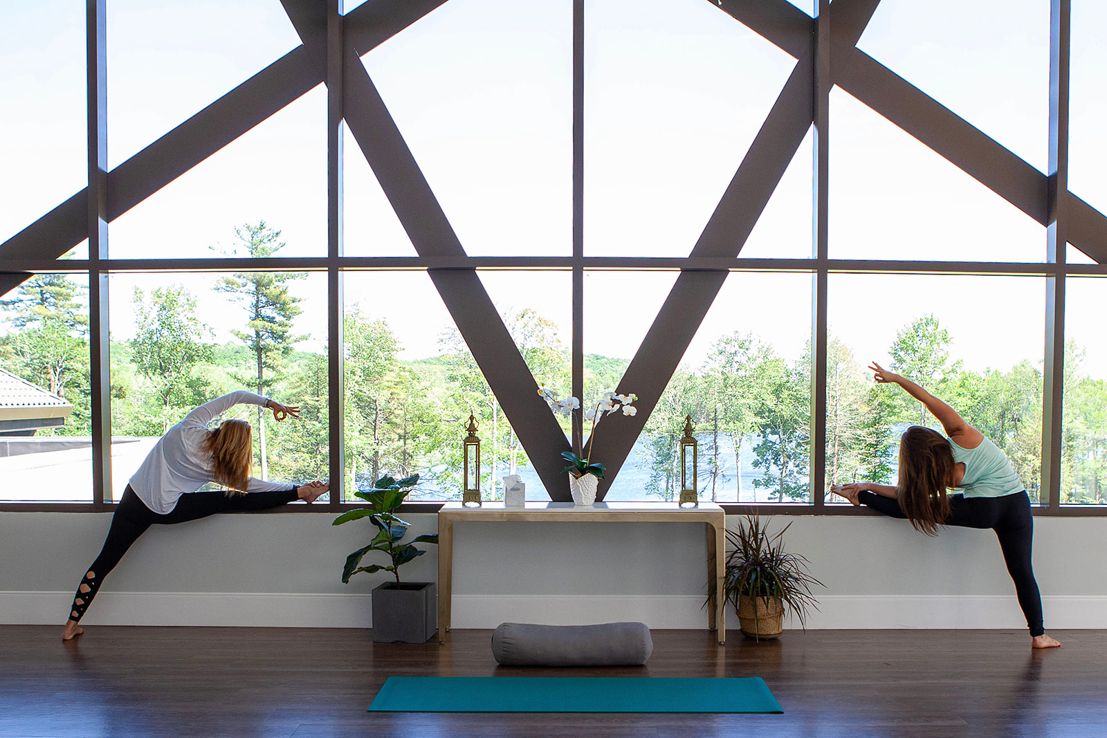 two women doing yoga in a room