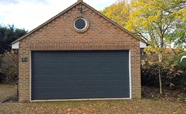 a brick garage with a round window