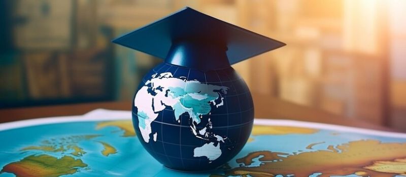 a globe with a graduation cap on top