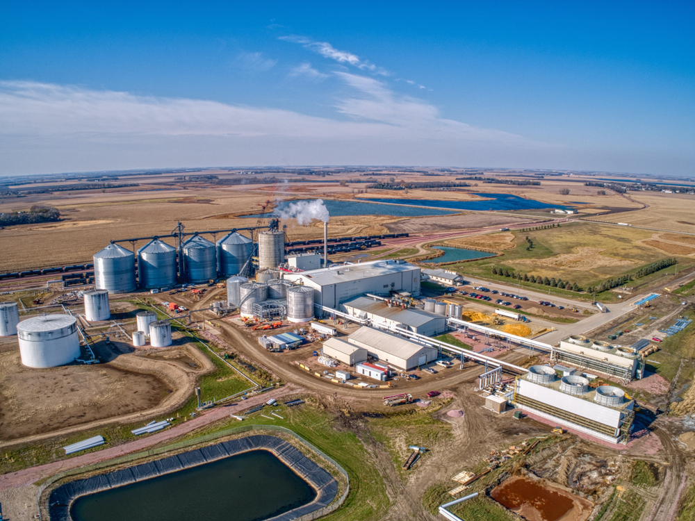 a factory with several silos and a water reservoir