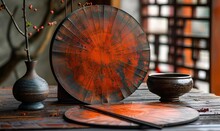 a red and black circular object on a table