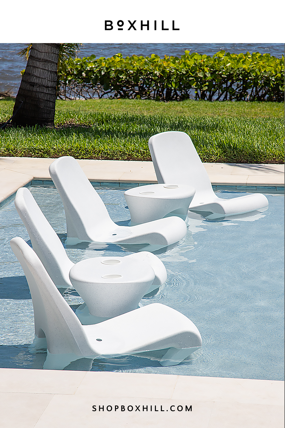 a pool with white chairs and tables