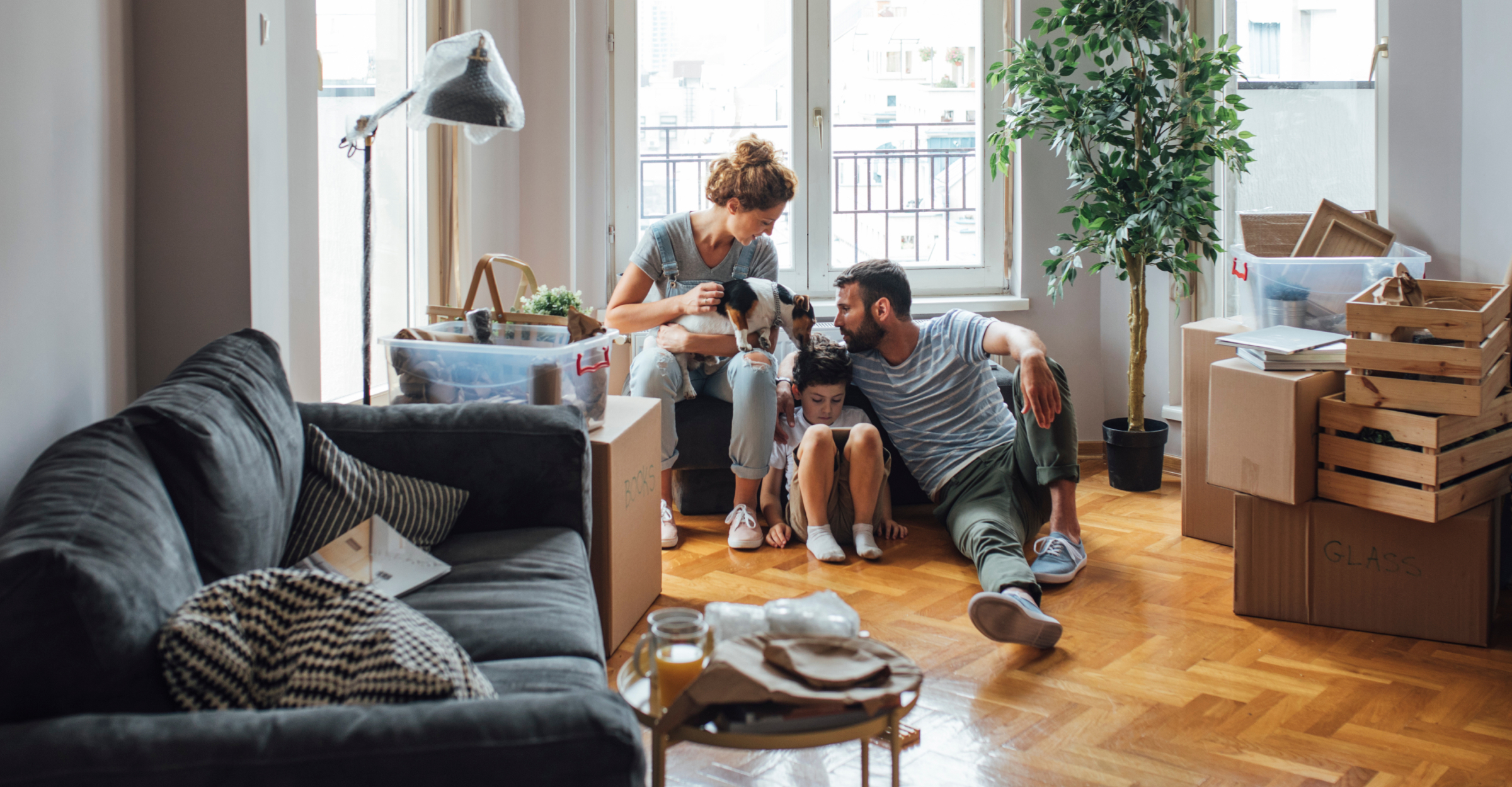 a family sitting on a couch with a dog