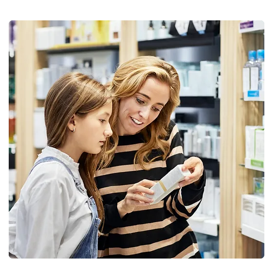 a woman and a girl looking at a product