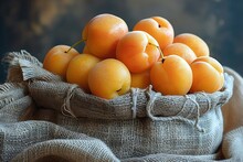 a group of yellow plums in a burlap bag