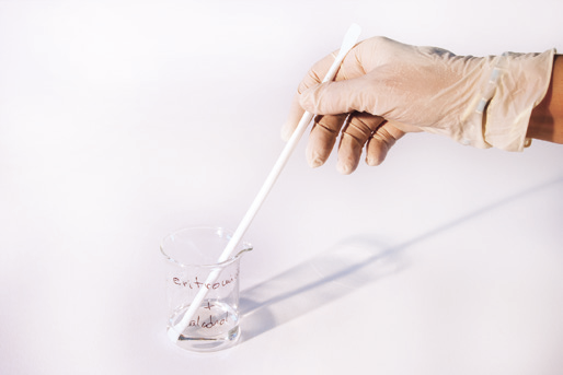 a hand holding a white plastic stick