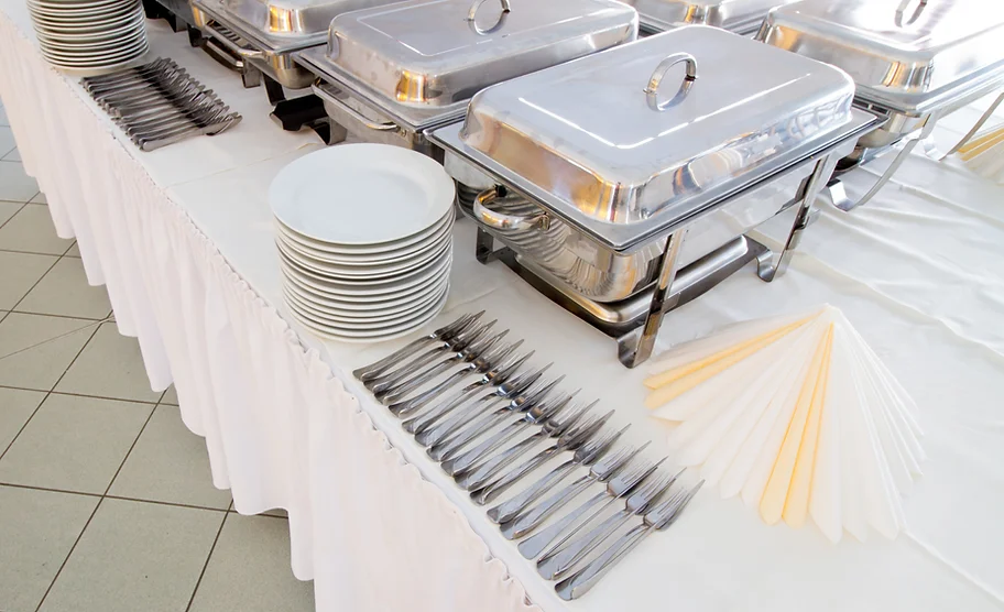 a buffet table with silverware and plates