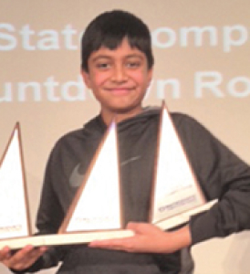 a boy holding a trophy