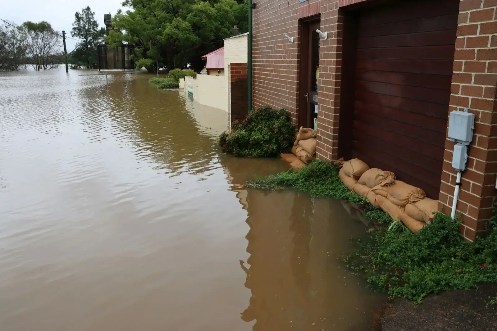 a flooded building with burlap sacks on the side