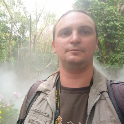 a man taking a selfie in a forest