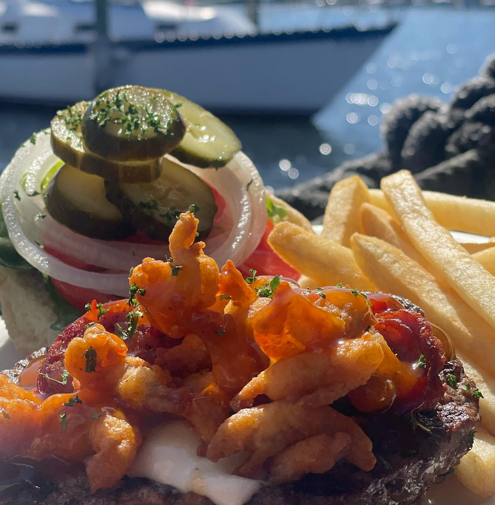 a plate of food with a boat in the background