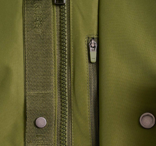 a zipper and buttons on a green jacket