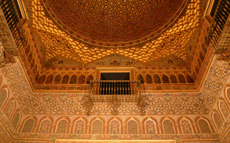 a gold ceiling with a balcony