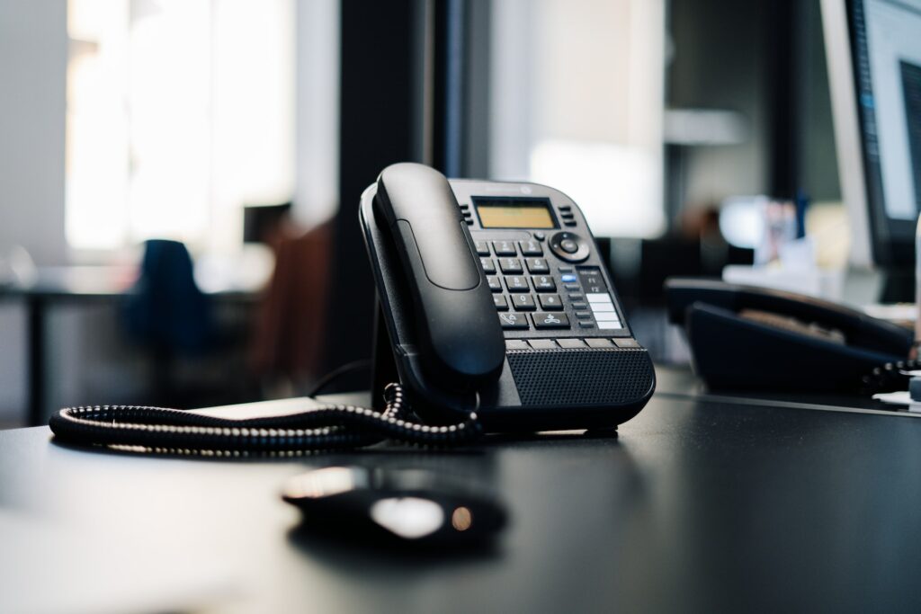 a black telephone on a desk