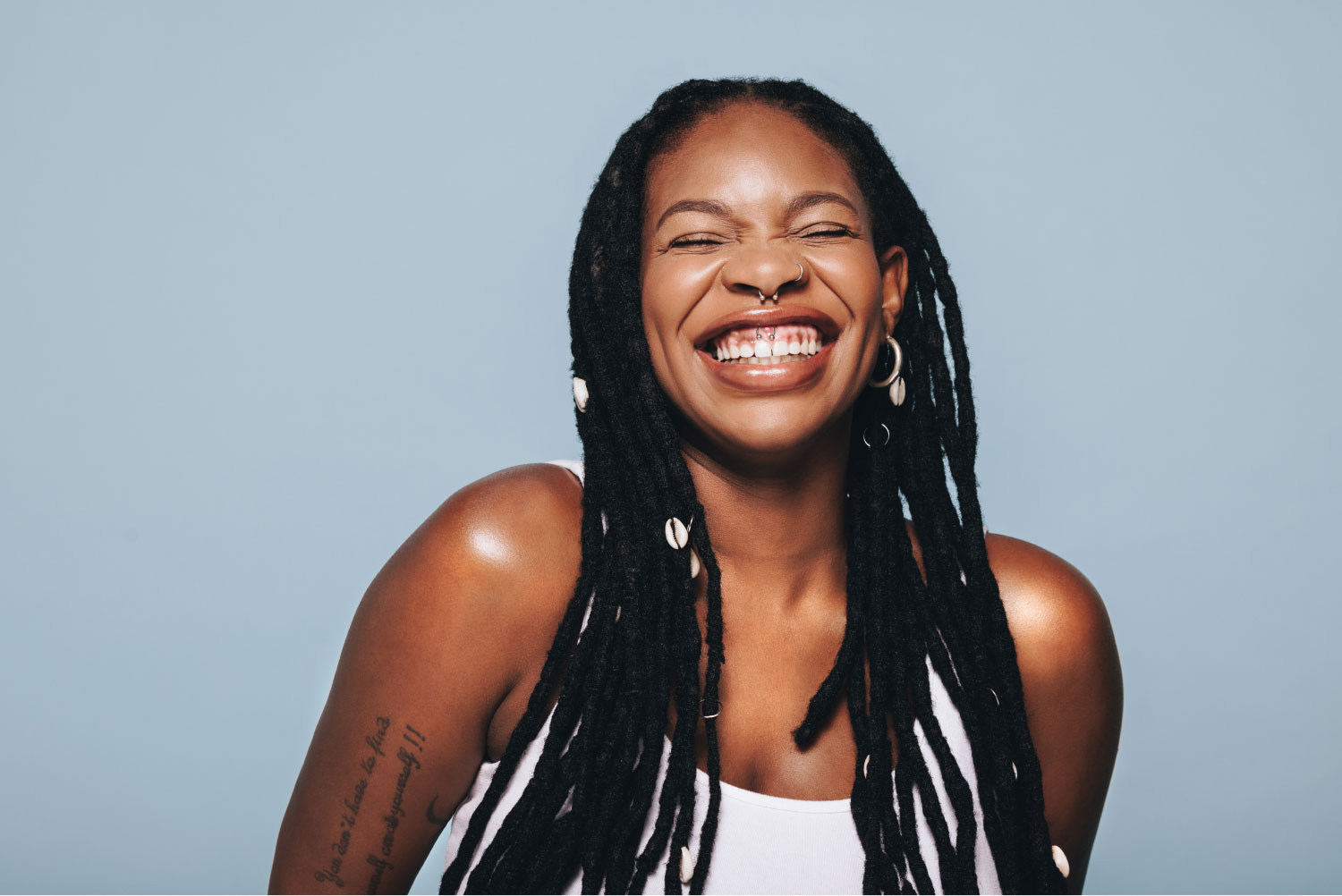 a woman with dreadlocks smiling