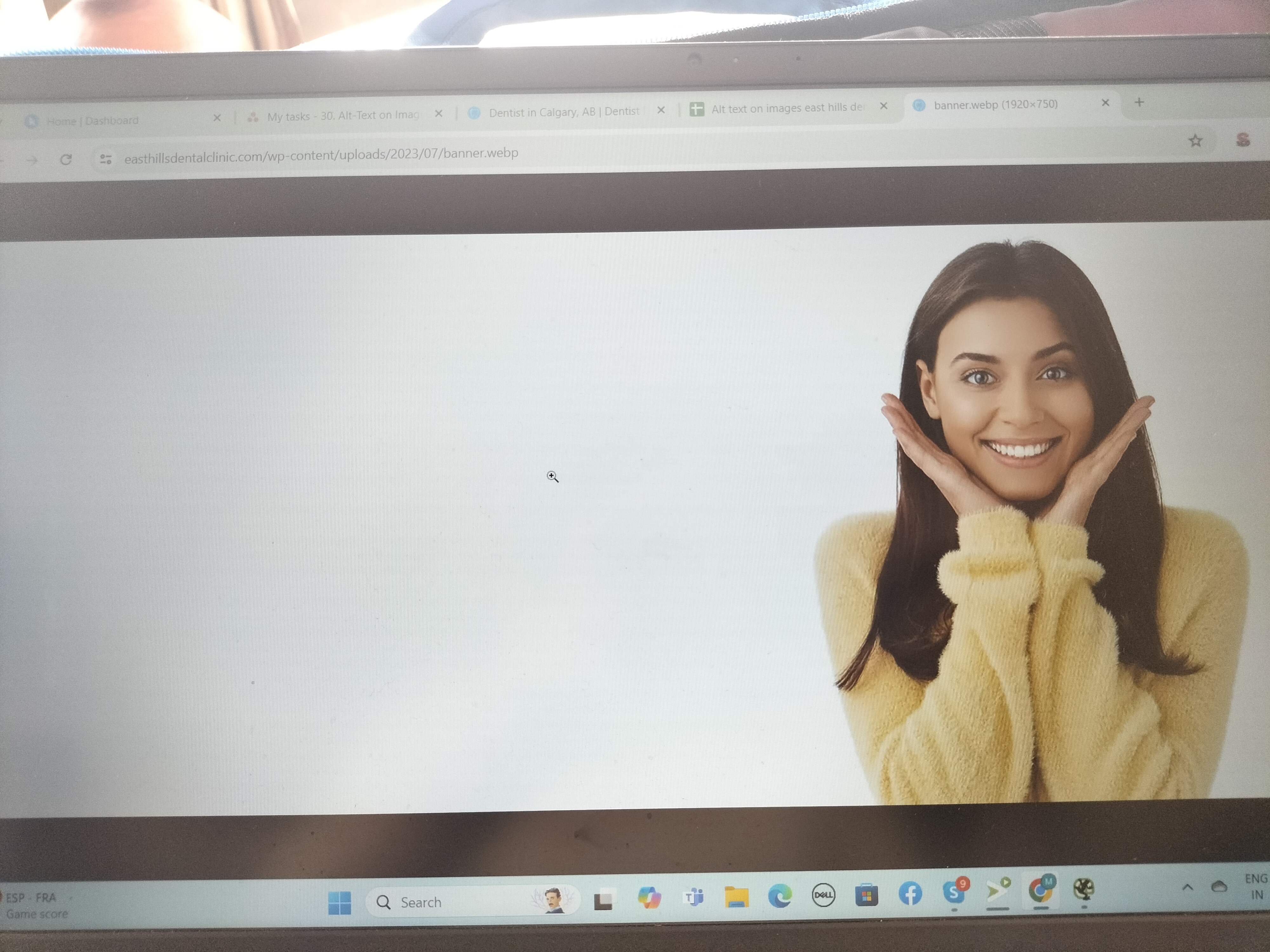 a woman smiling on a computer screen