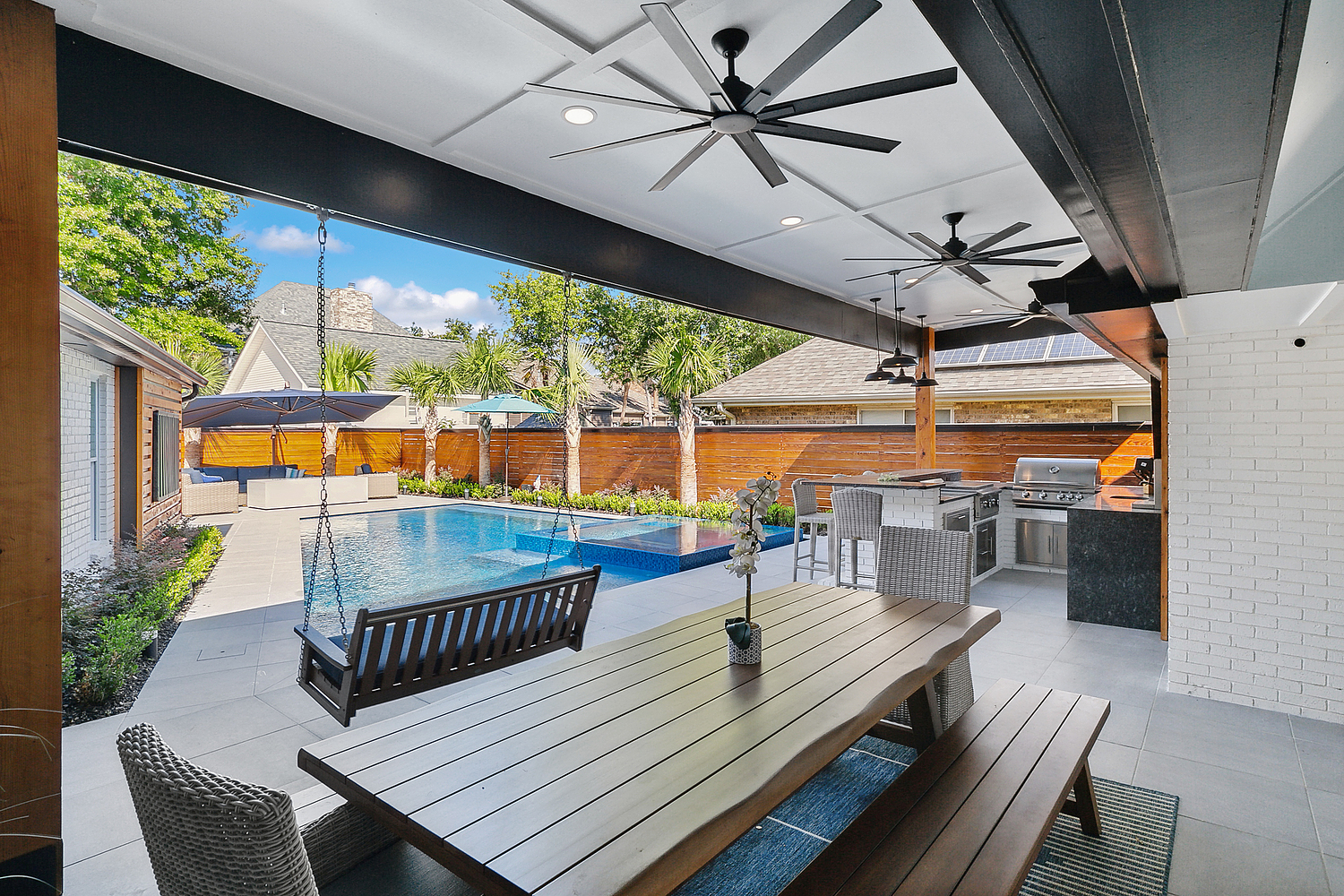 a patio with a pool and a table