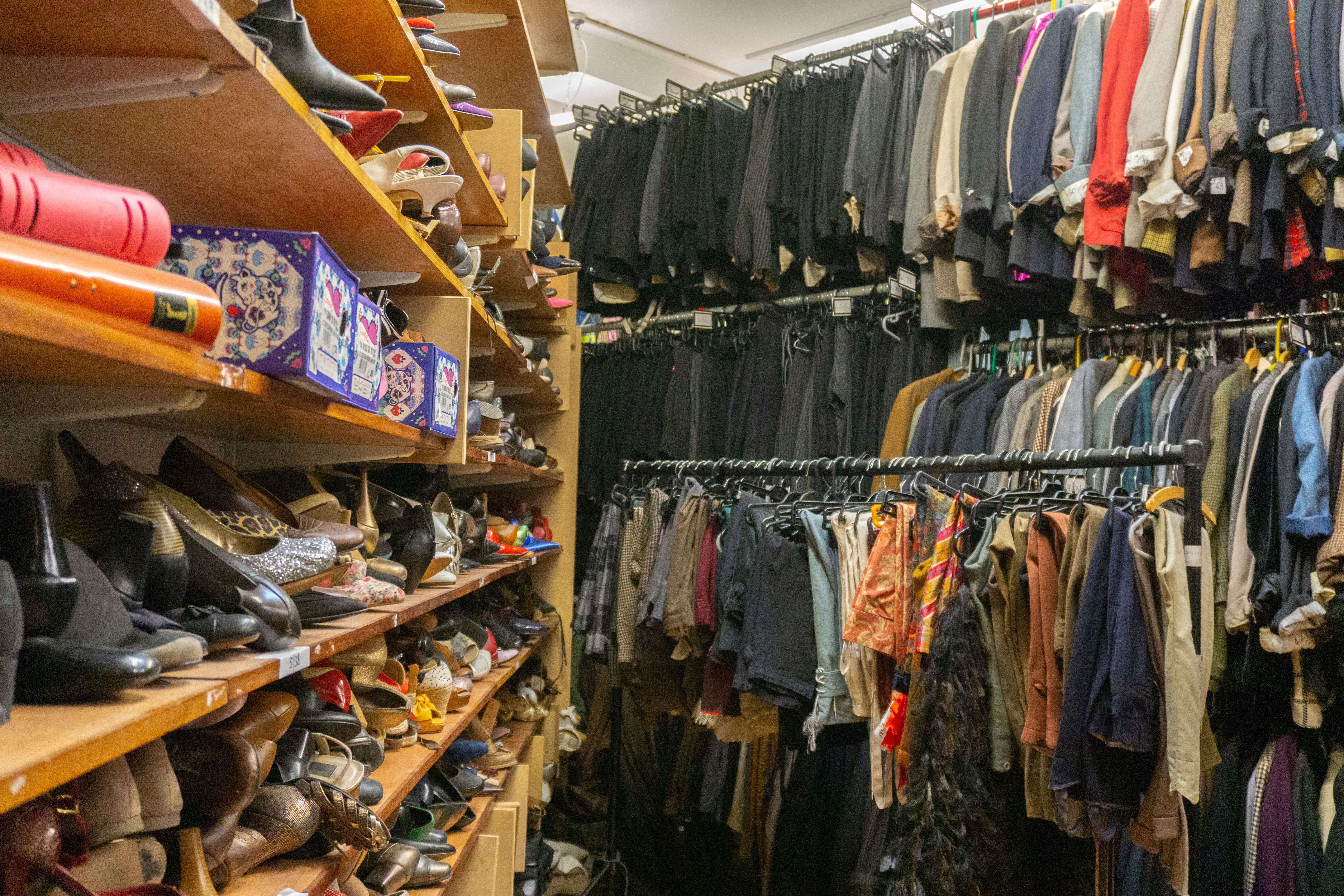 a closet with many shelves of clothes