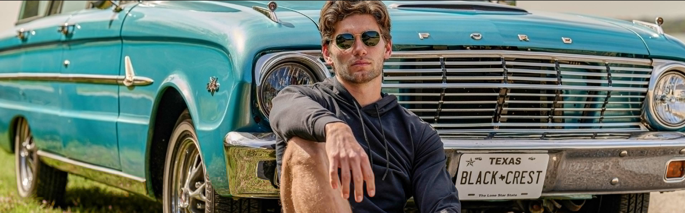 a man sitting in front of a car