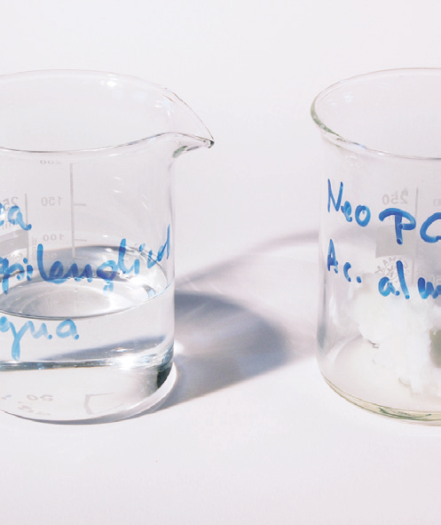 a glass beaker and a glass with liquid