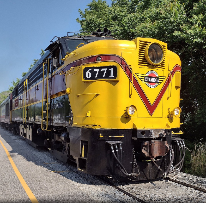 a yellow and black train on tracks