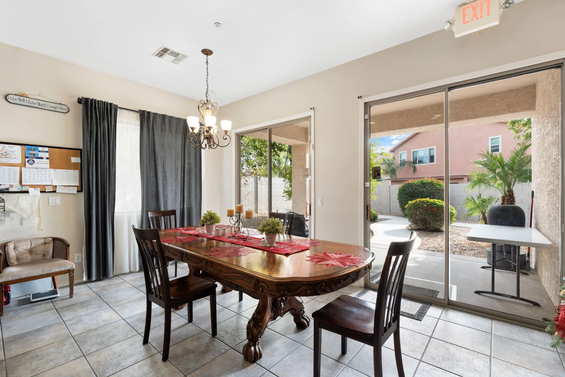 a dining table with chairs in a room with a glass door