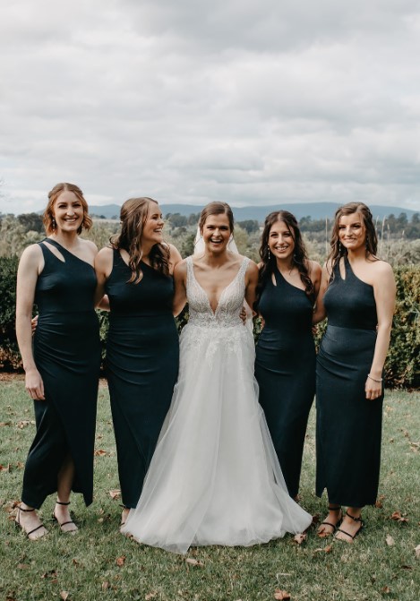 a group of women in black dresses