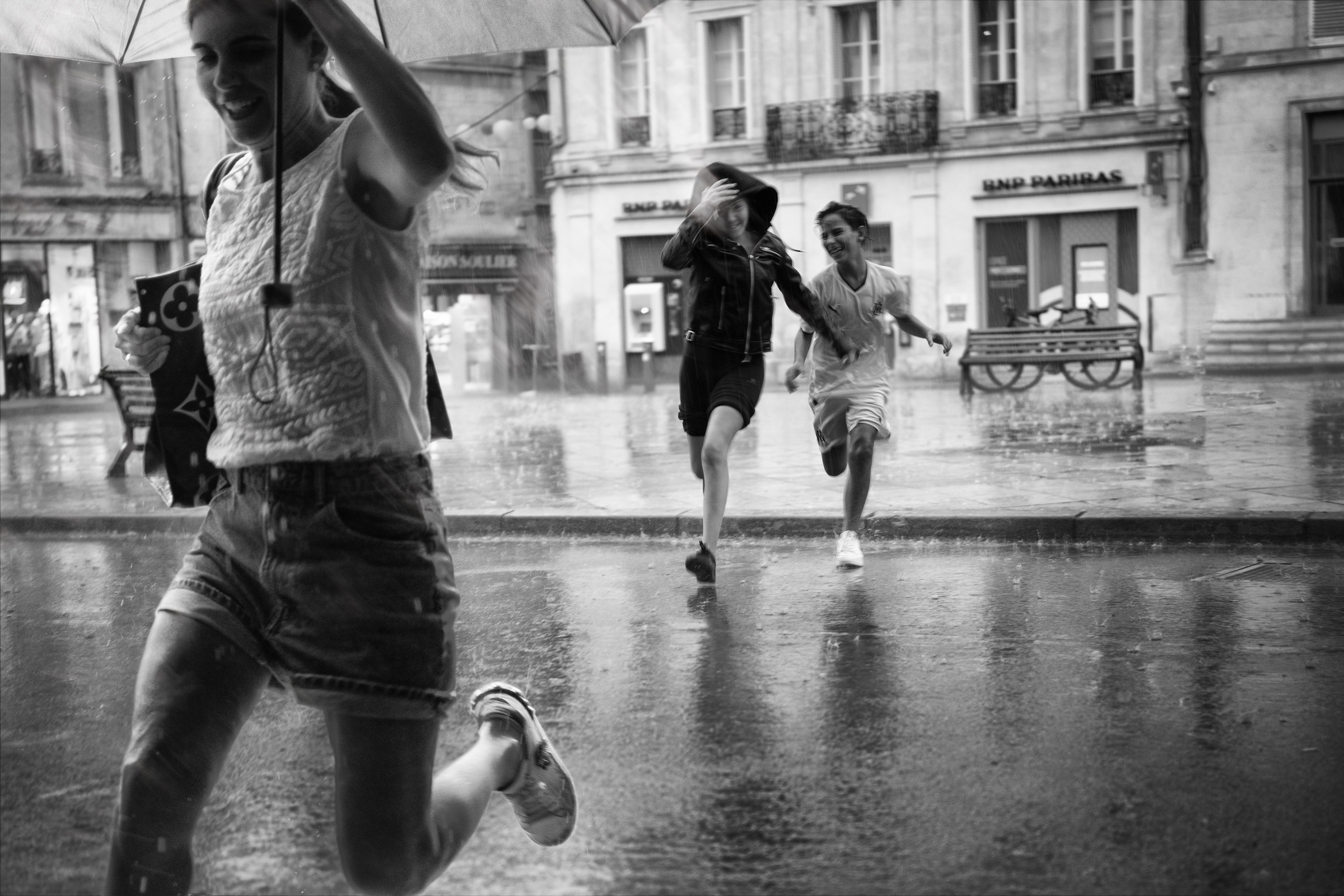 a group of people running in the rain
