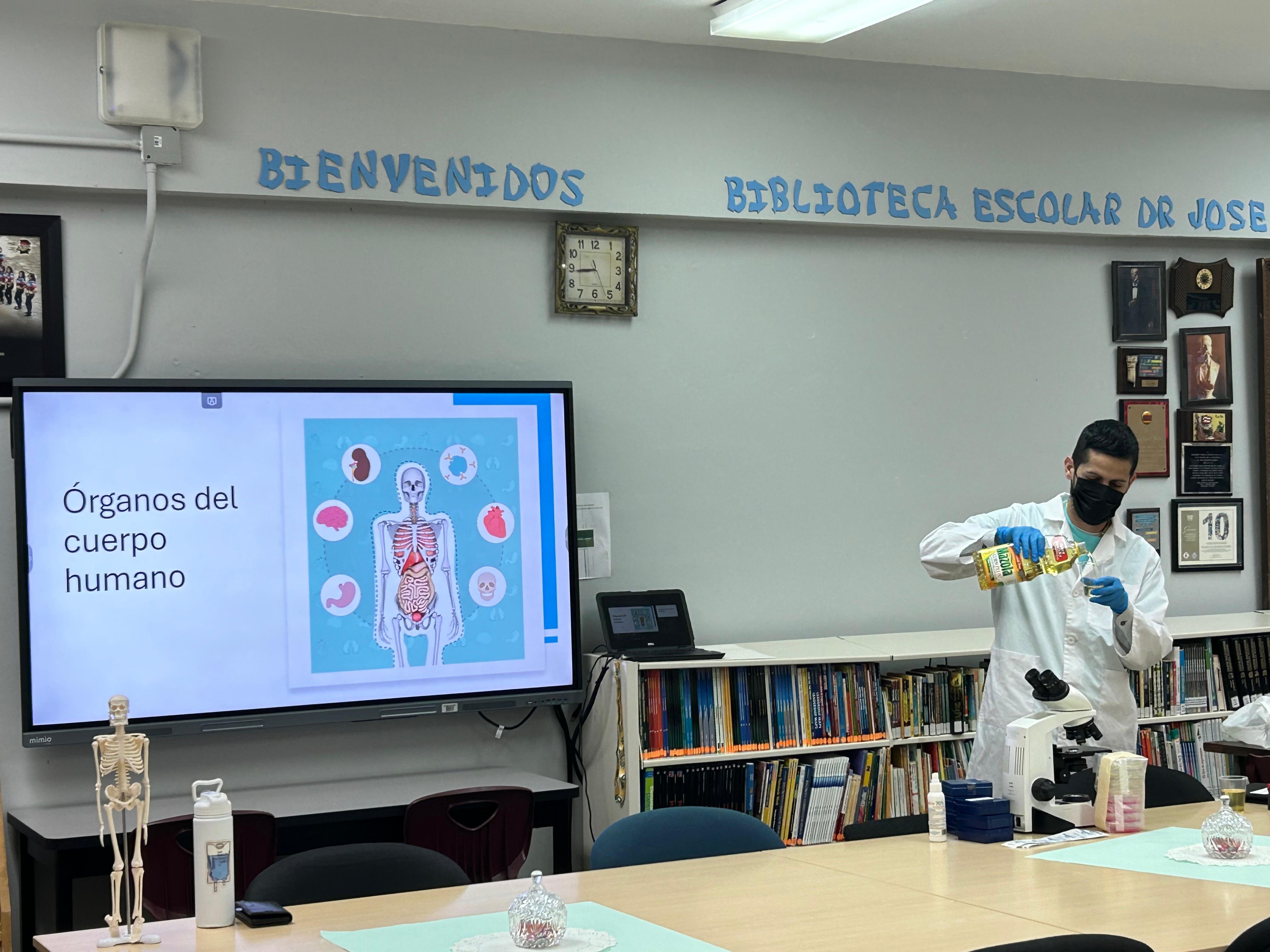 a man in a white suit and mask in a classroom