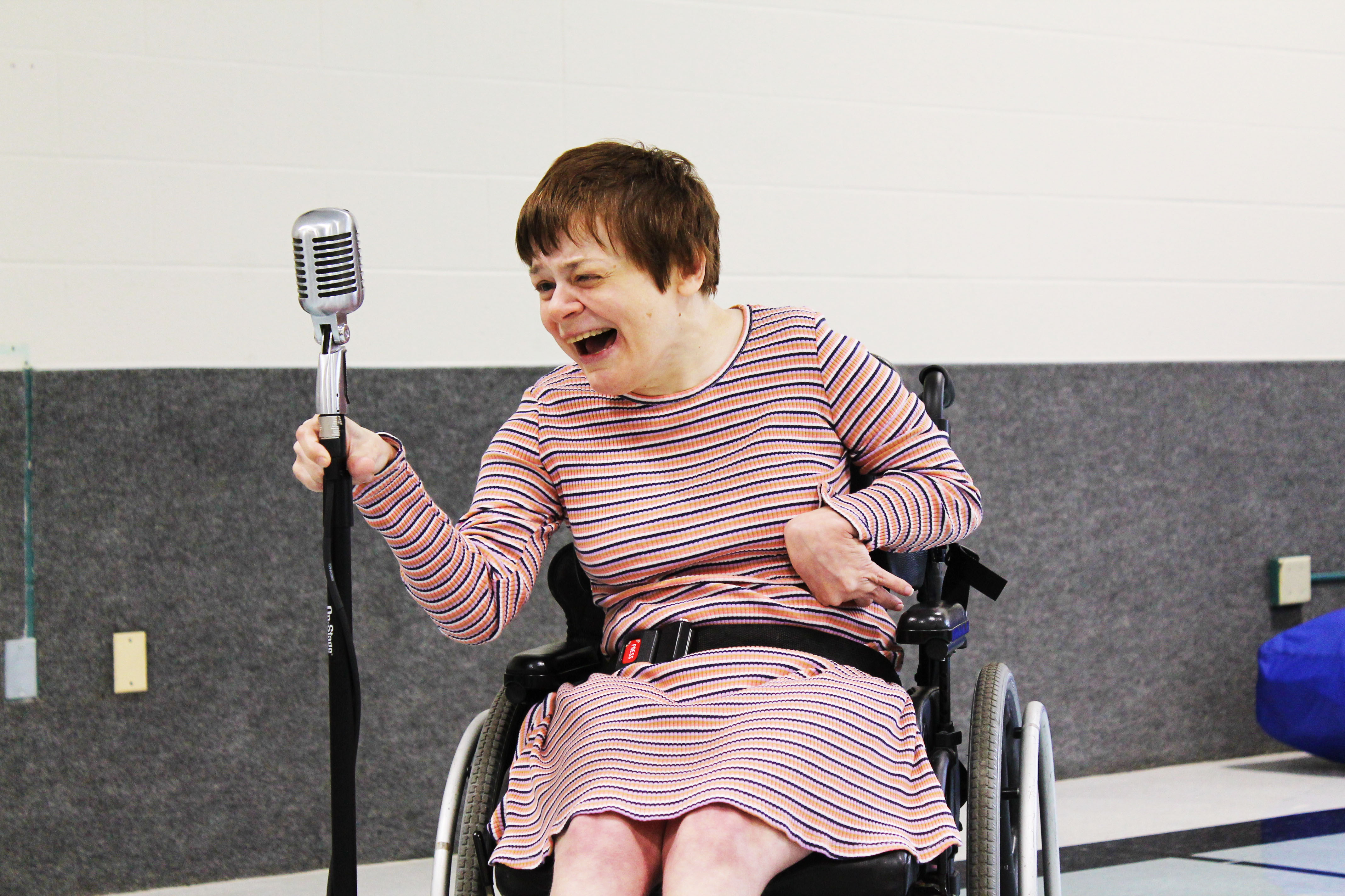 a woman in a wheelchair singing