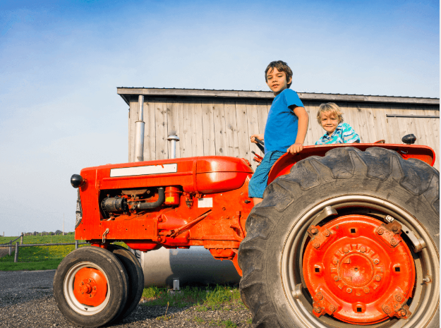 two boys on a tractor