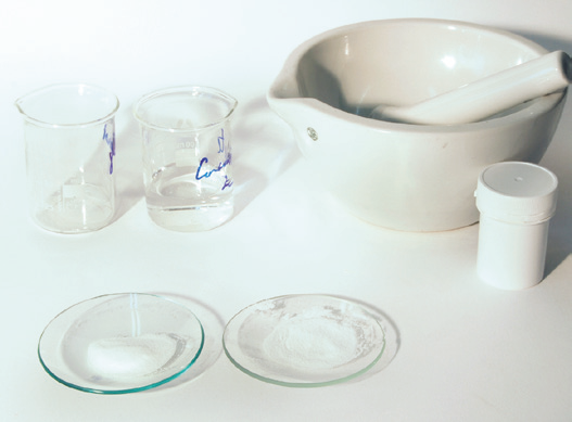 a mortar and pestle with a pestle and beakers