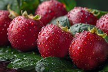 a group of red berries with water droplets on them