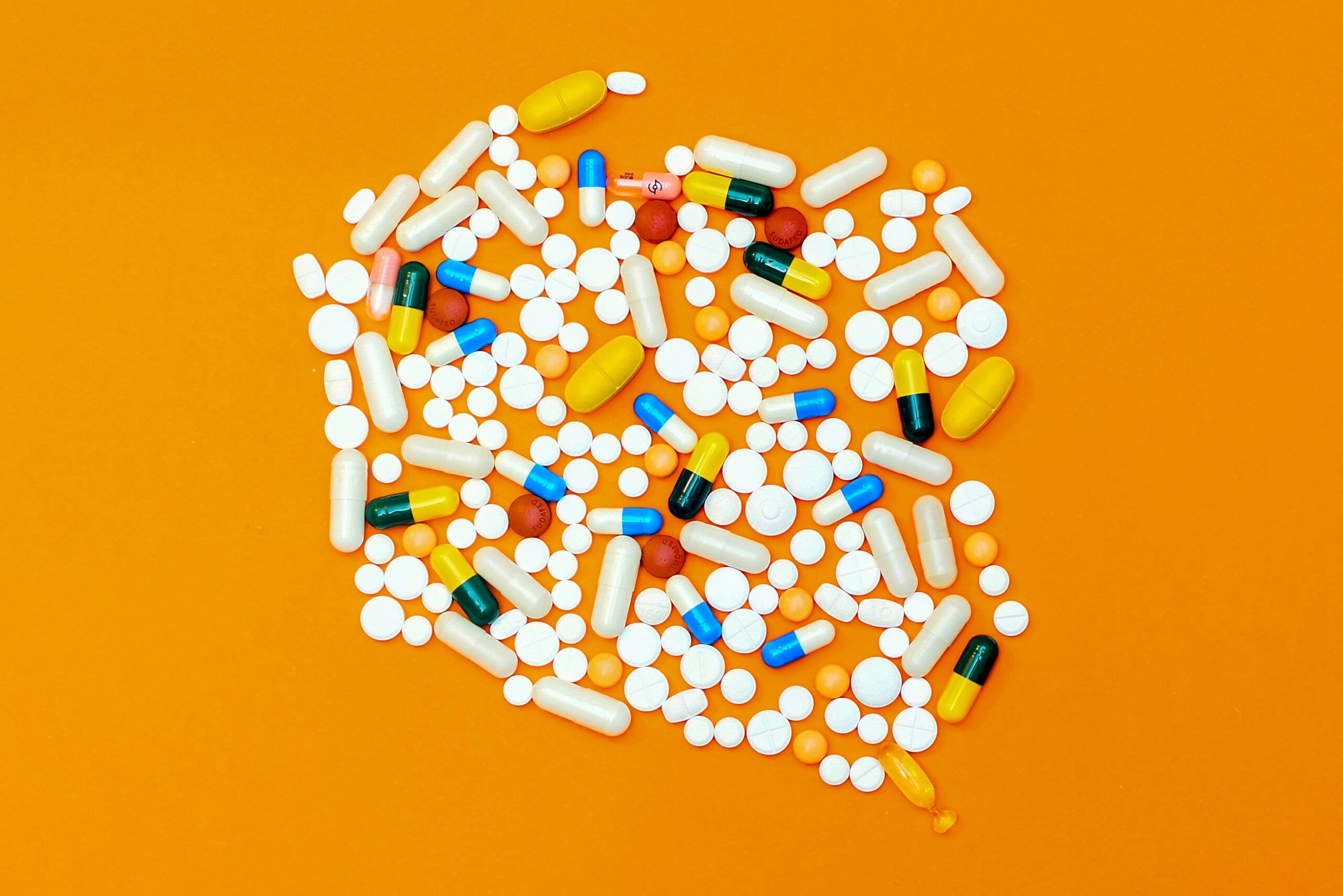 a group of pills and capsules