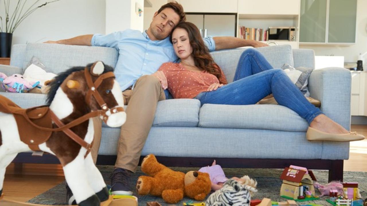 a man and woman sleeping on a couch