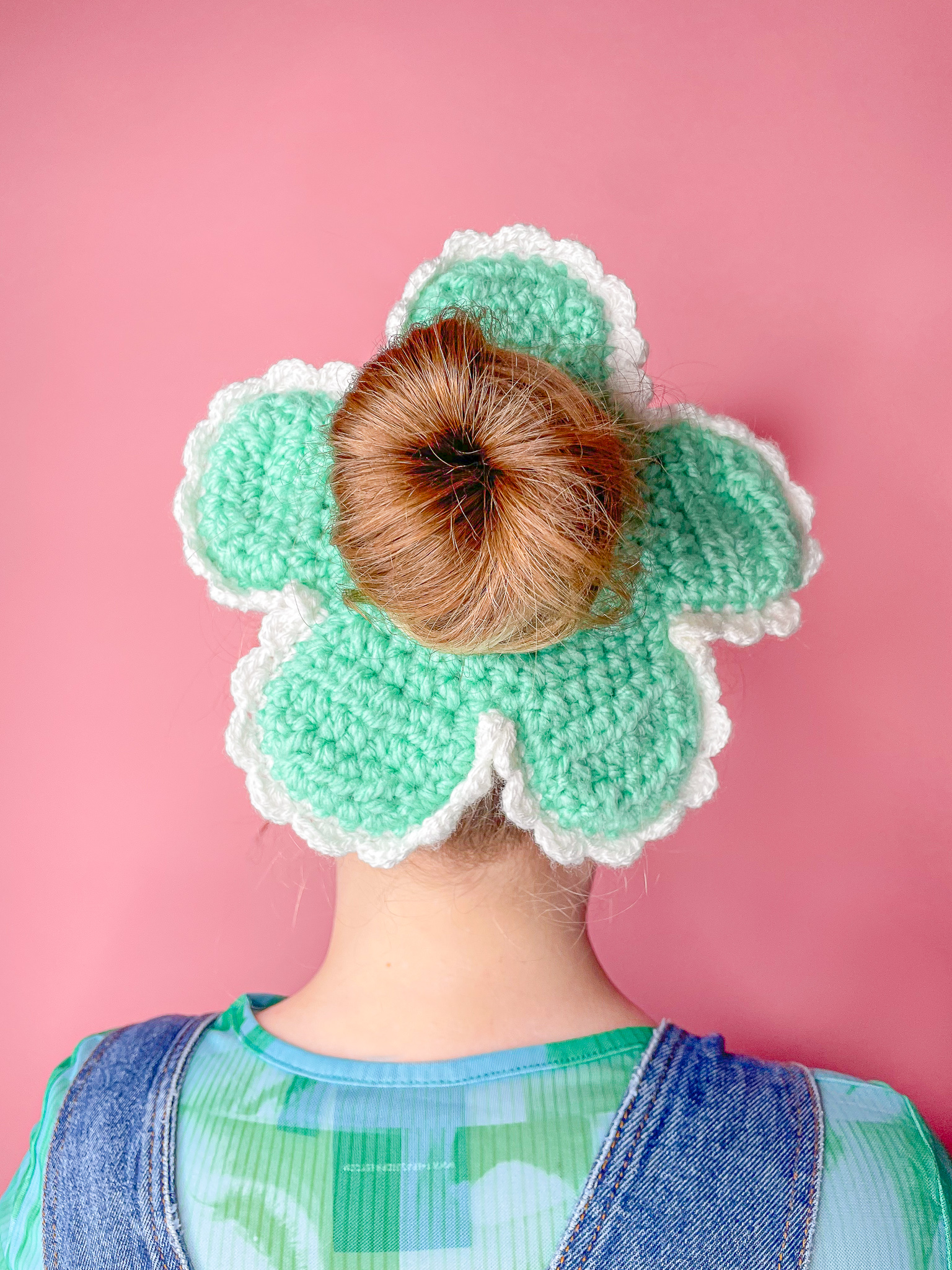 a woman wearing a knitted flower