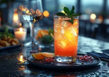 a glass of orange drink on a plate