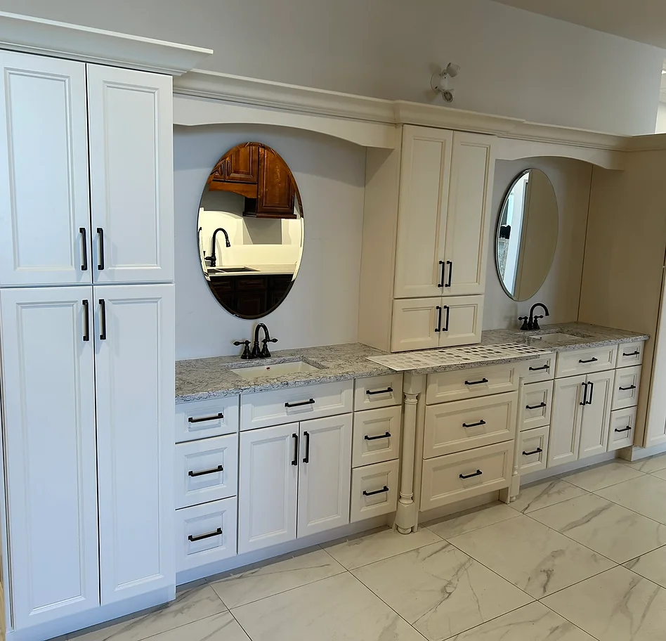 a bathroom with white cabinets and white countertops