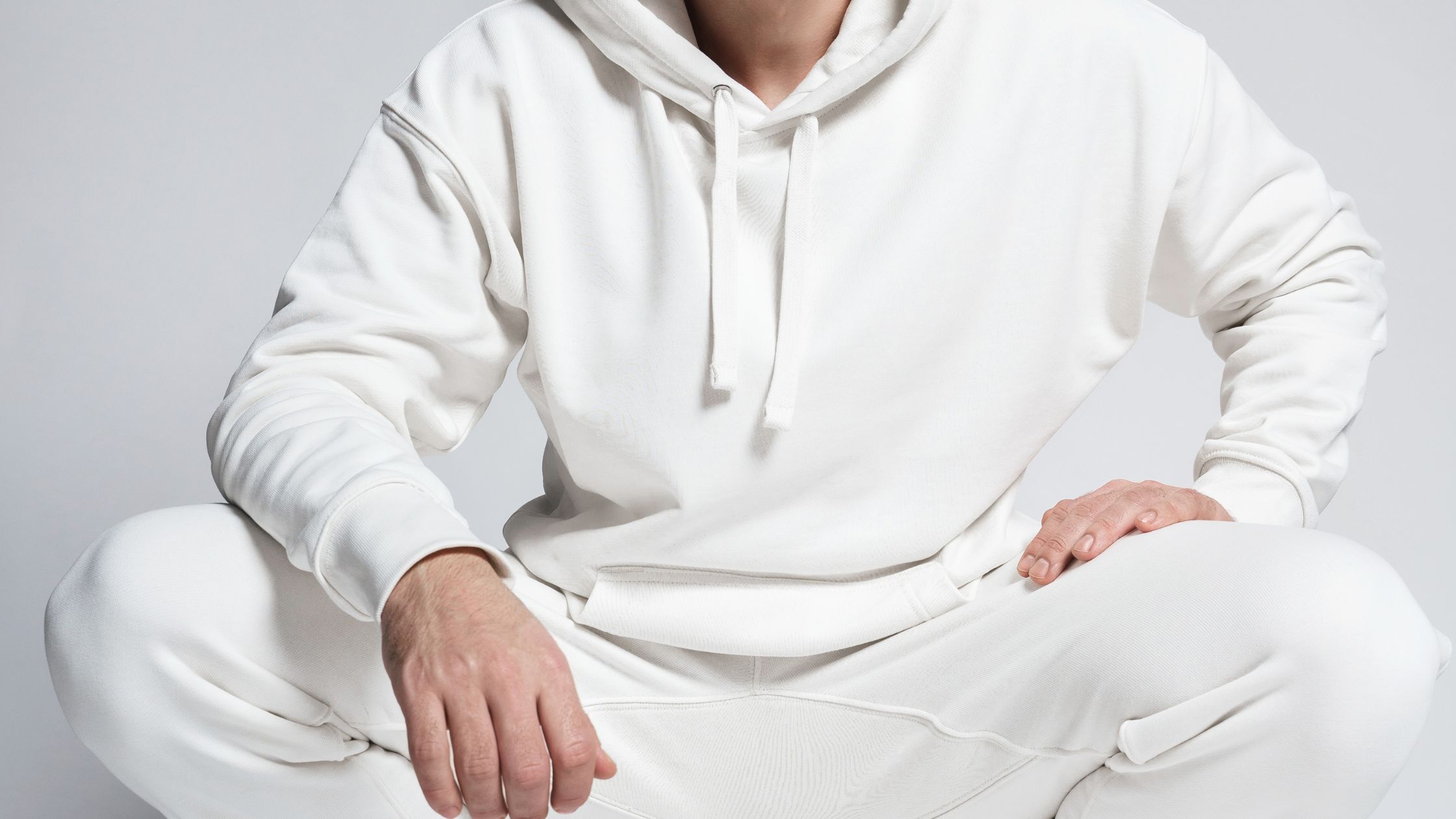 a person in white hoodie and white pants