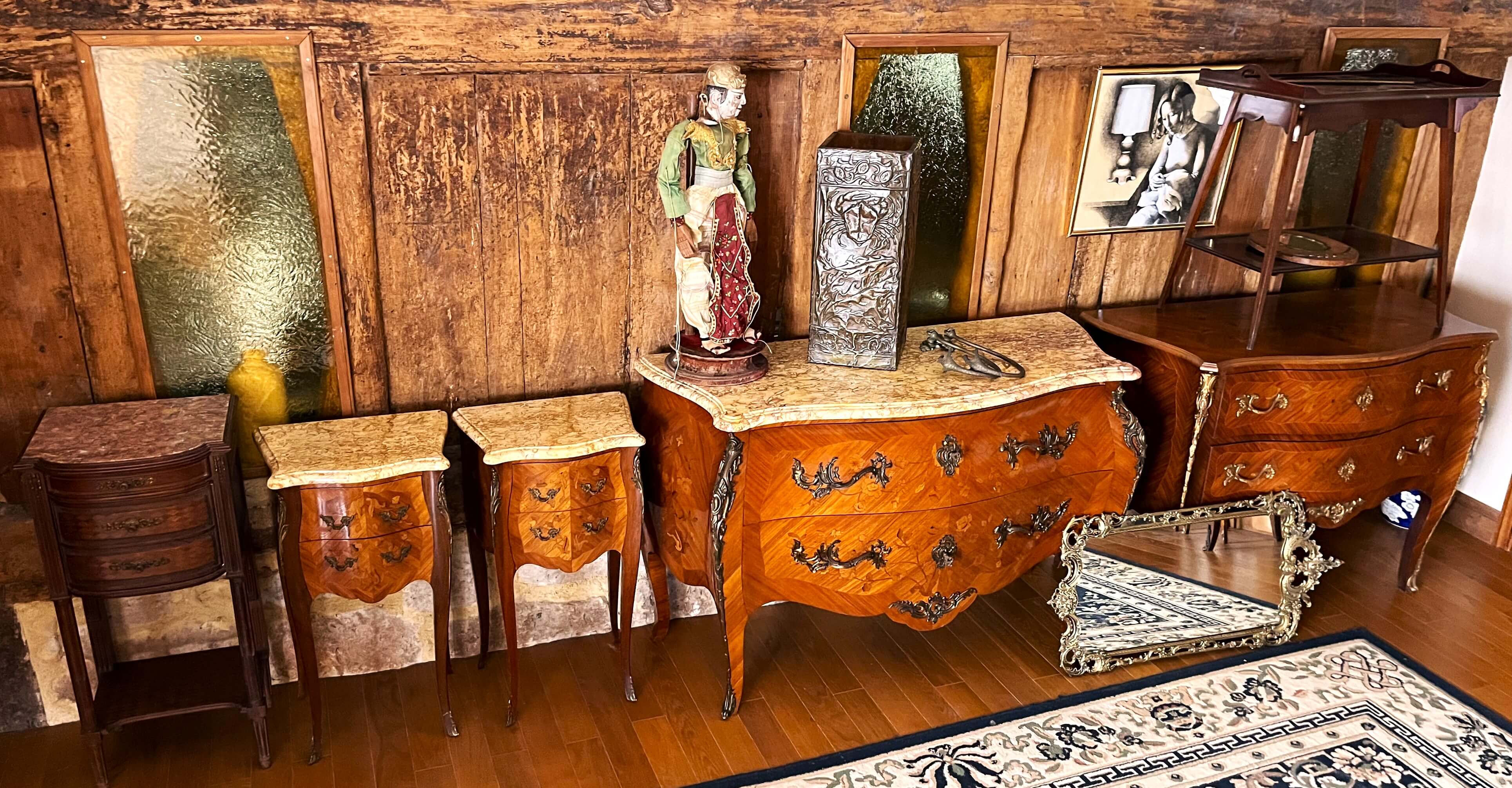 a wooden dresser with a statue on top of it