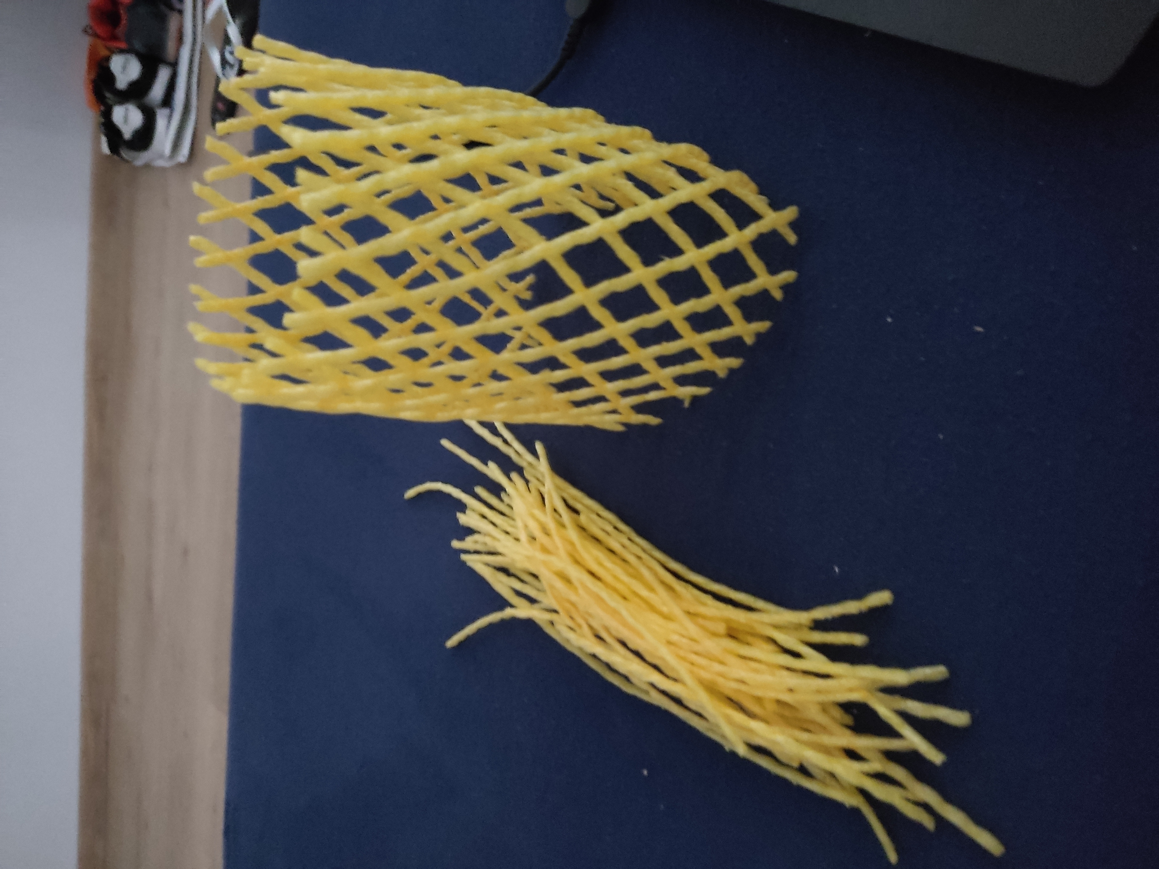 a yellow noodles on a blue surface