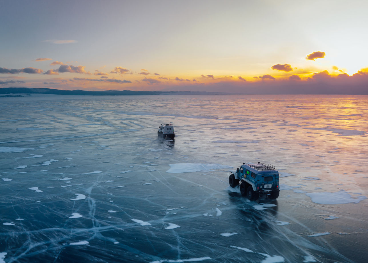 two vehicles driving on ice