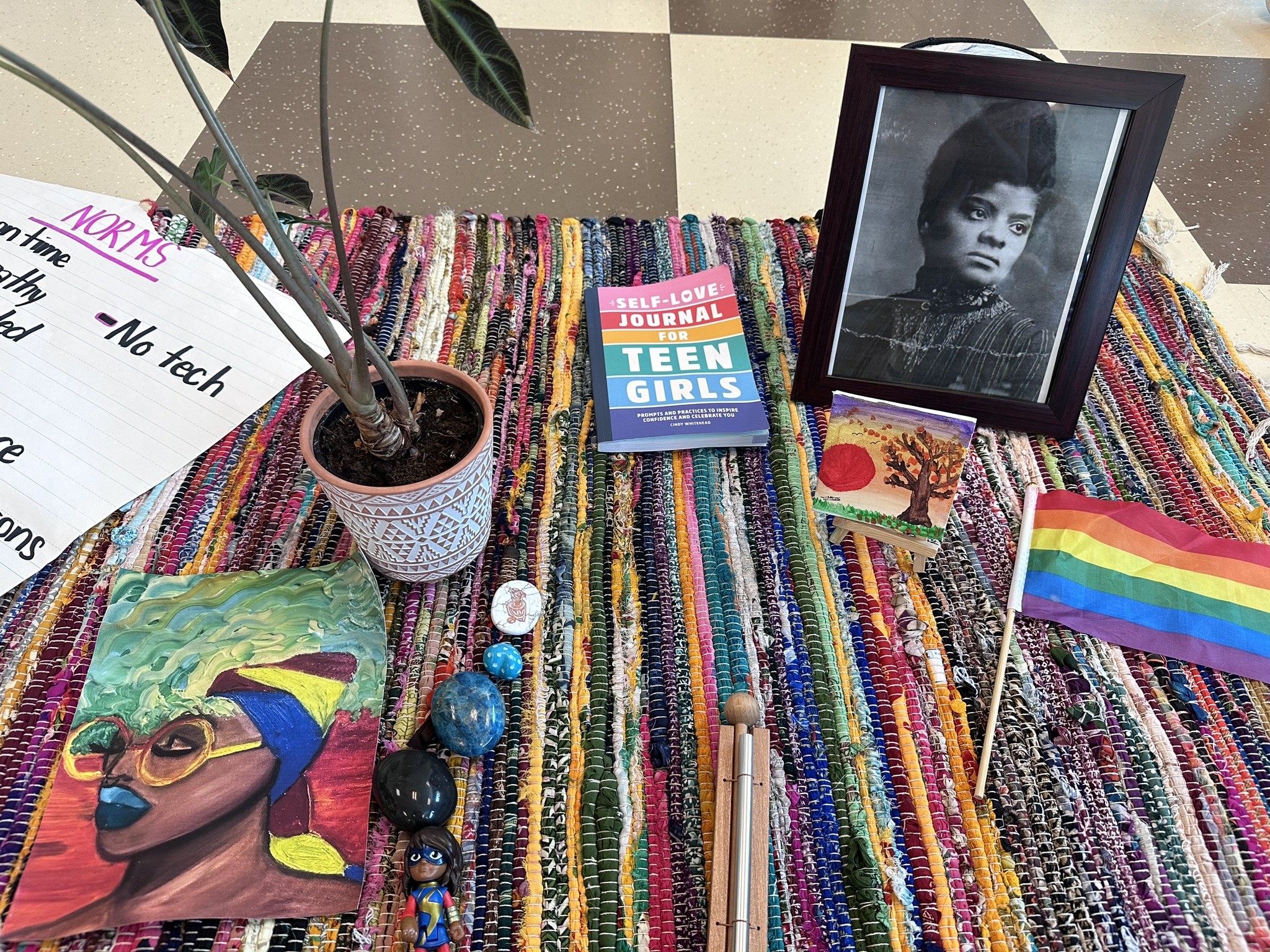 a table with a picture of a person and a potted plant