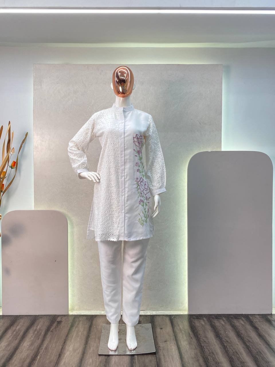 a mannequin wearing a white dress