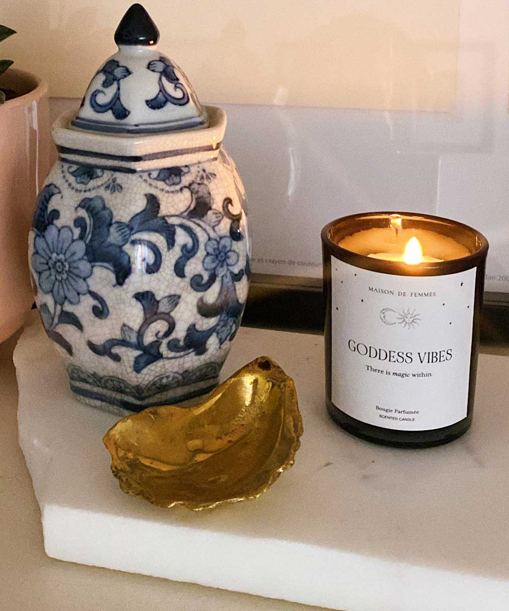 a candle and a jar on a table