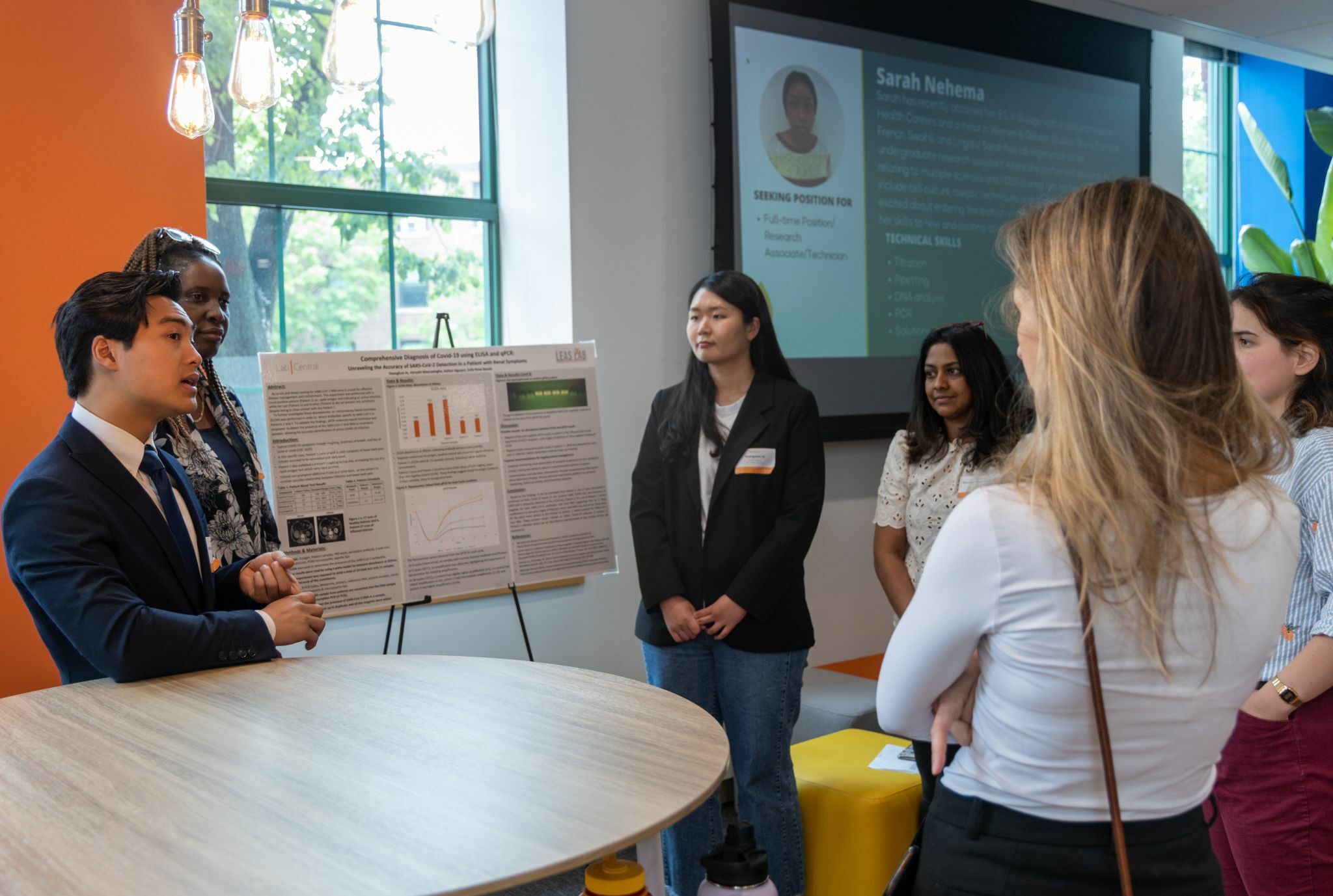 a woman standing in front of a table with a presentation