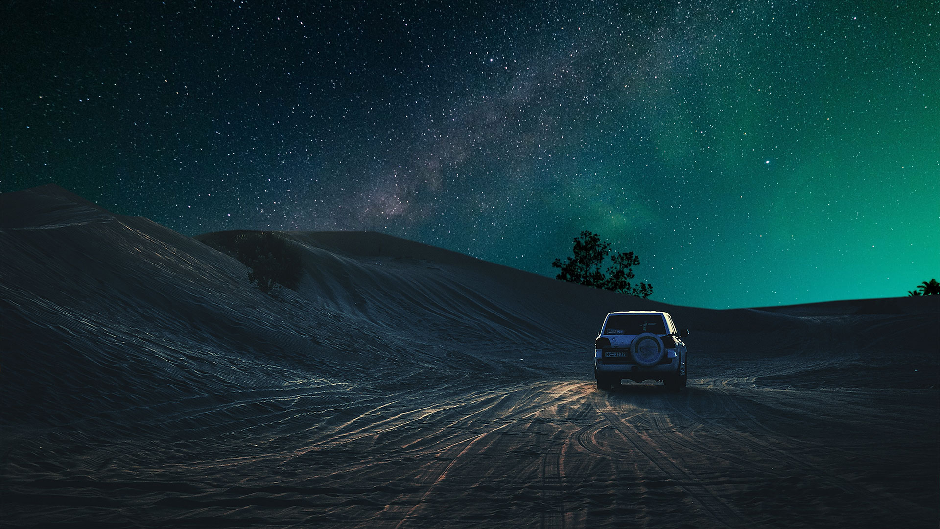 a car on a dirt road at night